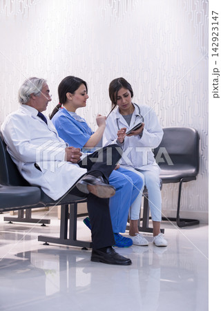 Doctors team meeting in a modern Middle Eastern eye hospital clinic in Egypt discussing patient care Doctors team meeting in a modern Middle Eastern eye hospital clinic in Egypt discussing patient care 142923147