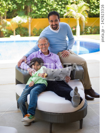 Middle Eastern Arab multi generation family relaxing by pool at modern luxury villa Middle Eastern Arab multi generation family relaxing by pool at modern luxury villa 142923316