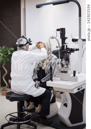 Ophthalmologist examining female patient in eye clinic during a medical eye exam in Egypt Ophthalmologist examining female patient in eye clinic during a medical eye exam in Egypt 142923584