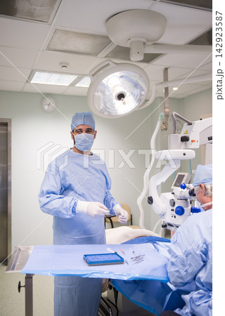 Eye surgeons performing ophthalmic surgery in a modern Middle Eastern hospital operating room in Egypt Eye surgeons performing ophthalmic surgery in a modern Middle Eastern hospital operating room in Egypt 142923587