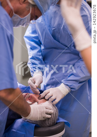 Eye surgery team performing delicate operation at a modern Middle Eastern eye hospital clinic in Egypt Eye surgery team performing delicate operation at a modern Middle Eastern eye hospital clinic in Egypt 142923678