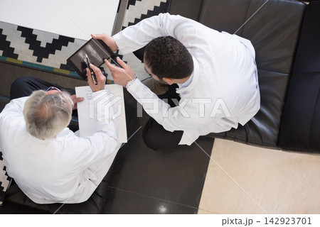 Doctors reviewing eye scan on tablet during hospital clinic meeting in a modern Egyptian ophthalmology unit 142923701