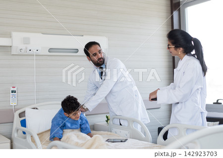 Eye hospital doctors consulting with a young patient in a modern Middle Eastern clinic in Egypt Eye hospital doctors consulting with a young patient in a modern Middle Eastern clinic in Egypt 142923703