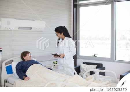 Female doctor consulting with an older patient in a modern Middle Eastern eye hospital room in Egypt Female doctor consulting with an older patient in a modern Middle Eastern eye hospital room in Egypt 142923879