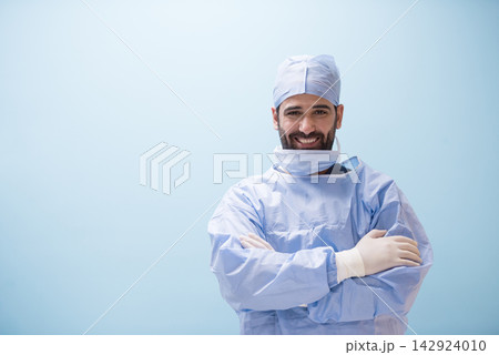 Confident Middle Eastern surgeon in scrubs at an eye hospital clinic in Egypt smiling with arms crossed Confident Middle Eastern surgeon in scrubs at an eye hospital clinic in Egypt smiling with arms crossed 142924010