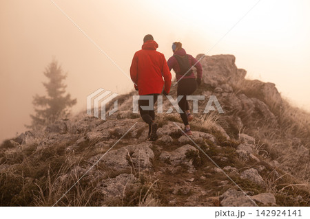 Trail Running Couple On Rocky Mountain Ridge At Sunrise Foggy Morning Adventure 142924141