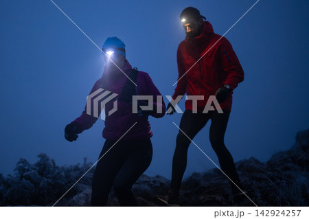Night Trail Running Couple With Headlamps On Frosty Mountain Path Training Together Night Trail Running Couple With Headlamps On Frosty Mountain Path Training Together 142924257