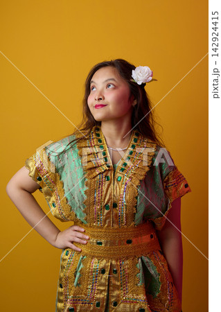 Young Indonesian Asian Woman in Gold Embroidered Traditional Dress With White Flower in Hair Portrait Young Indonesian Asian Woman in Gold Embroidered Traditional Dress With White Flower in Hair Portrait 142924415