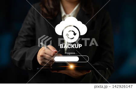Professional hand holding tablet with cloud backup icon and progress bar, representing technology, data security and digital solutions for businesses Ledger 142926147
