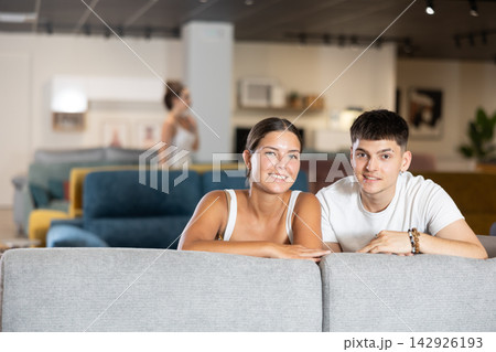 Couple man and woman choosing sofa in store Couple man and woman choosing sofa in store 142926193