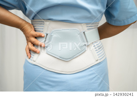Asian senior pain back wearing elastic support belt with walker. Asian senior pain back wearing elastic support belt with walker. 142930241