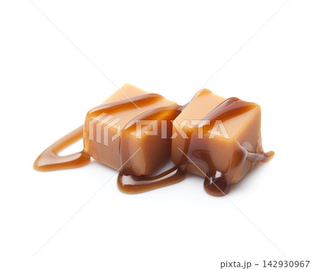 Caramel candies with caramel topping on white backgrounds 142930967