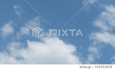 Puffy white clouds drifting across a bright blue sky background Puffy white clouds drifting across a bright blue sky background 142932658