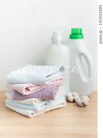 Stack of soft clean towels with laundry detergents Stack of soft clean towels with laundry detergents 142932885