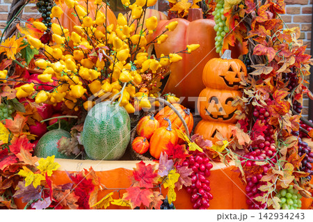Smiling Jack O lantern pumpkin  with fruits. Halloween decoration 142934243