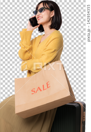 Happy asian woman talking phone holding paper bag discussing artificial intelligence chatbot shopping assistant with joyful emotional expression near luggage on transparency background 142934355