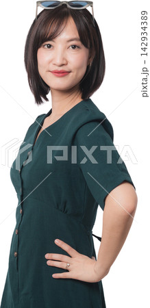 Confident modern young asian woman standing with hand on hip representing artificial intelligence chatbot developer smiling warmly against transparency background studio setup 142934389