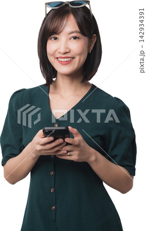 Happy asian woman holding smartphone using artificial intelligence chatbot app with joyful expression isolated on transparency background for mobile communication technology context 142934391