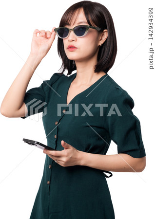 Stylish young asian woman holding smartphone while adjusting sunglasses with confident serious expression using artificial intelligence chatbot technology on transparency background Stylish young asian woman holding smartphone while adjusting sunglasses with confident serious expression using artificial intelligence chatbot technology on transparency background 142934399