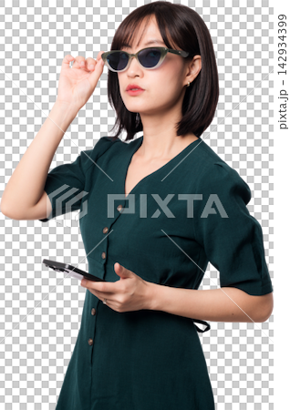 Stylish young asian woman holding smartphone while adjusting sunglasses with confident serious expression using artificial intelligence chatbot technology on transparency background Stylish young asian woman holding smartphone while adjusting sunglasses with confident serious expression using artificial intelligence chatbot technology on transparency background 142934399