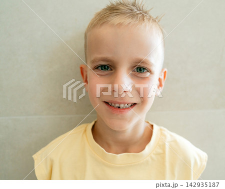 Cheerful boy looking at camera with open smile displaying gap from lost first tooth. Children healthcare, oral hygiene, primary tooth replacement, and joyful lifestyle Cheerful boy looking at camera with open smile displaying gap from lost first tooth. Children healthcare, oral hygiene, primary tooth replacement, and joyful lifestyle 142935187