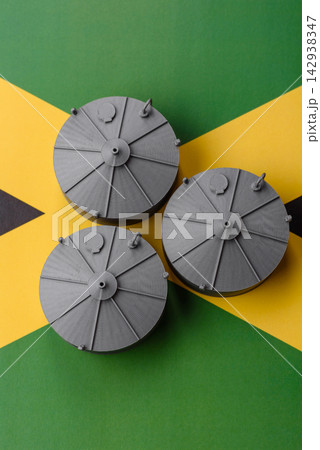 Liquefied gas storage tanks set against the Jamaica flag, concept of supply and distribution Liquefied gas storage tanks set against the Jamaica flag, concept of supply and distribution 142938347