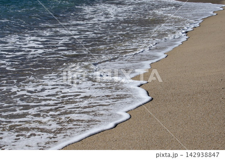 Ocean Surf and White Foam Along Golden Sandy Shore Ocean Surf and White Foam Along Golden Sandy Shore 142938847