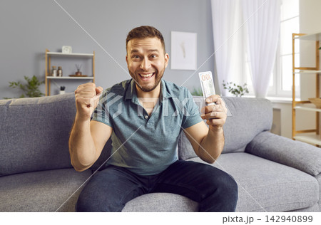 Happy Man Celebrating Financial Success With Stack Of Cash Happy Man Celebrating Financial Success With Stack Of Cash 142940899