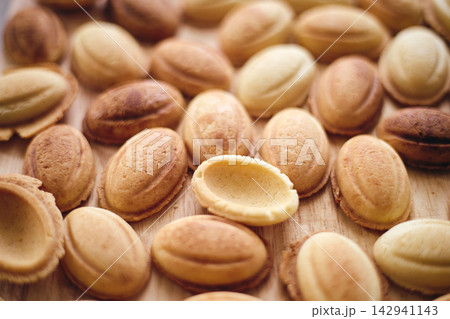 Traditional Walnut Shaped Cookies Oreshki on Wooden Background Traditional Walnut Shaped Cookies Oreshki on Wooden Background 142941143