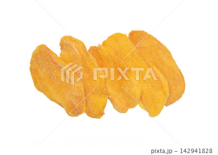 Slices of dried mango isolated on white background. 142941828