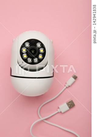 Security camera on pink background. Outdoor surveillance camera. Vertical photo Security camera on pink background. Outdoor surveillance camera. Vertical photo 142941838
