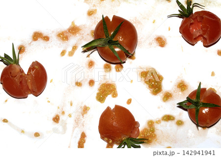A squashed splattered and crushed broken fresh tomato with seeds A squashed splattered and crushed broken fresh tomato with seeds 142941941