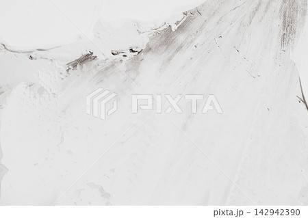 Textured white canvas background displaying broad brush strokes over dark underlayer designed for contemporary art background or modern interior wall plaster effect 142942390