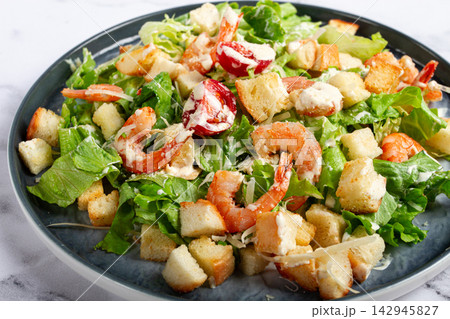 Caesar salad, with shrimp, on a marble background, top view, no people, Caesar salad, with shrimp, on a marble background, top view, no people, 142945827