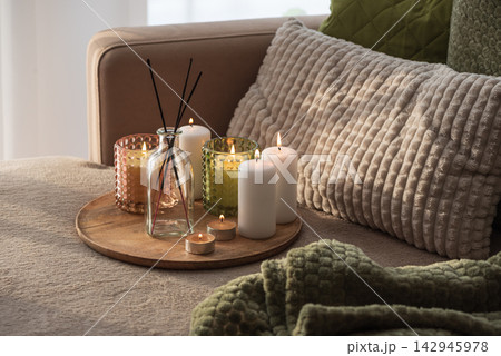 Home interior decor setup with scented candles and diffuser on a tray cozy atmosphere Home interior decor setup with scented candles and diffuser on a tray cozy atmosphere 142945978