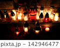 Candles glow warmly on stone surface 142946477