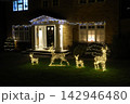 The front of a house decorated for the holidays at night. 142946480