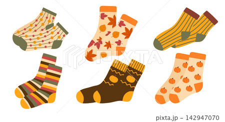 Set of cozy autumn socks with pumpkins, leaves, stripes and warm seasonal patterns. Cute flat vector illustrations isolated on white background. Set of cozy autumn socks with pumpkins, leaves, stripes and warm seasonal patterns. Cute flat vector illustrations isolated on white background. 142947070