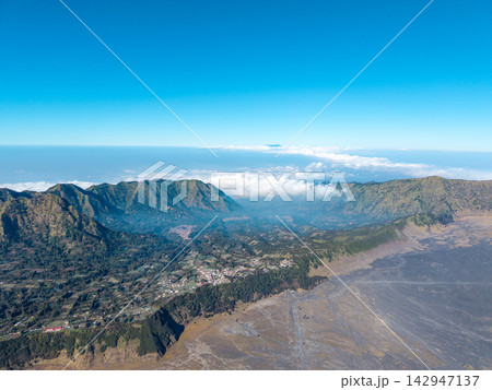 Clear blue sky meets rugged mountain peaks 142947137