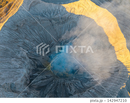 Volcano erupts, releasing mist and smoke 142947210