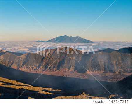 Mountains rise above a sea of clouds Mountains rise above a sea of clouds 142947212