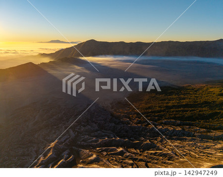 Golden sunbeams pierce mist laden valleys 142947249