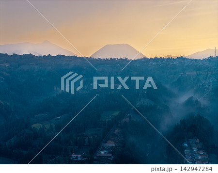 Misty hills fade into golden dawn Misty hills fade into golden dawn 142947284