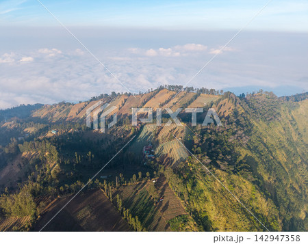 Aerial View of Terraced Farmland and Cloudy Hillsides in Wonotoro, Sukapura Aerial View of Terraced Farmland and Cloudy Hillsides in Wonotoro, Sukapura 142947358