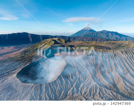 Aerial Mount Bromo Caldera and Rugged Volcanic Mountains in Daylight 142947369