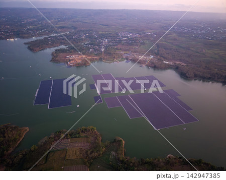 Aerial View of Solar Panels on Water Surfaces in Green Landscape 142947385