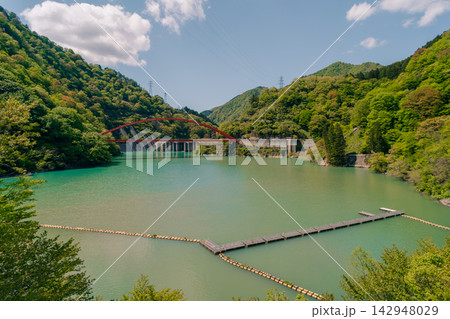 Kurobe Gorge Railway in Japan, a scenic mountain railway passing through deep valleys, bridges, and tunnels along a picturesque natural landscape. Kurobe Gorge Railway in Japan, a scenic mountain railway passing through deep valleys, bridges, and tunnels along a picturesque natural landscape. 142948029