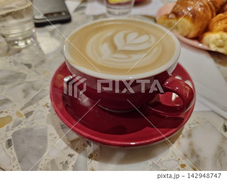 Red Cup of Cappuccino with Latte Art in Cordoba Cafe 142948747
