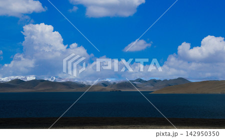 Serene Tibetan Plateau Landscape with Snow Capped Mountains and Blue Lake Serene Tibetan Plateau Landscape with Snow Capped Mountains and Blue Lake 142950350