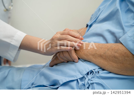 Asian doctor checking and treat elderly woman patient health in hospital. 142951394